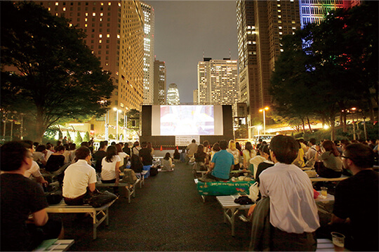 新宿の夜景を背景に映画を楽しむ屋外上映イベント